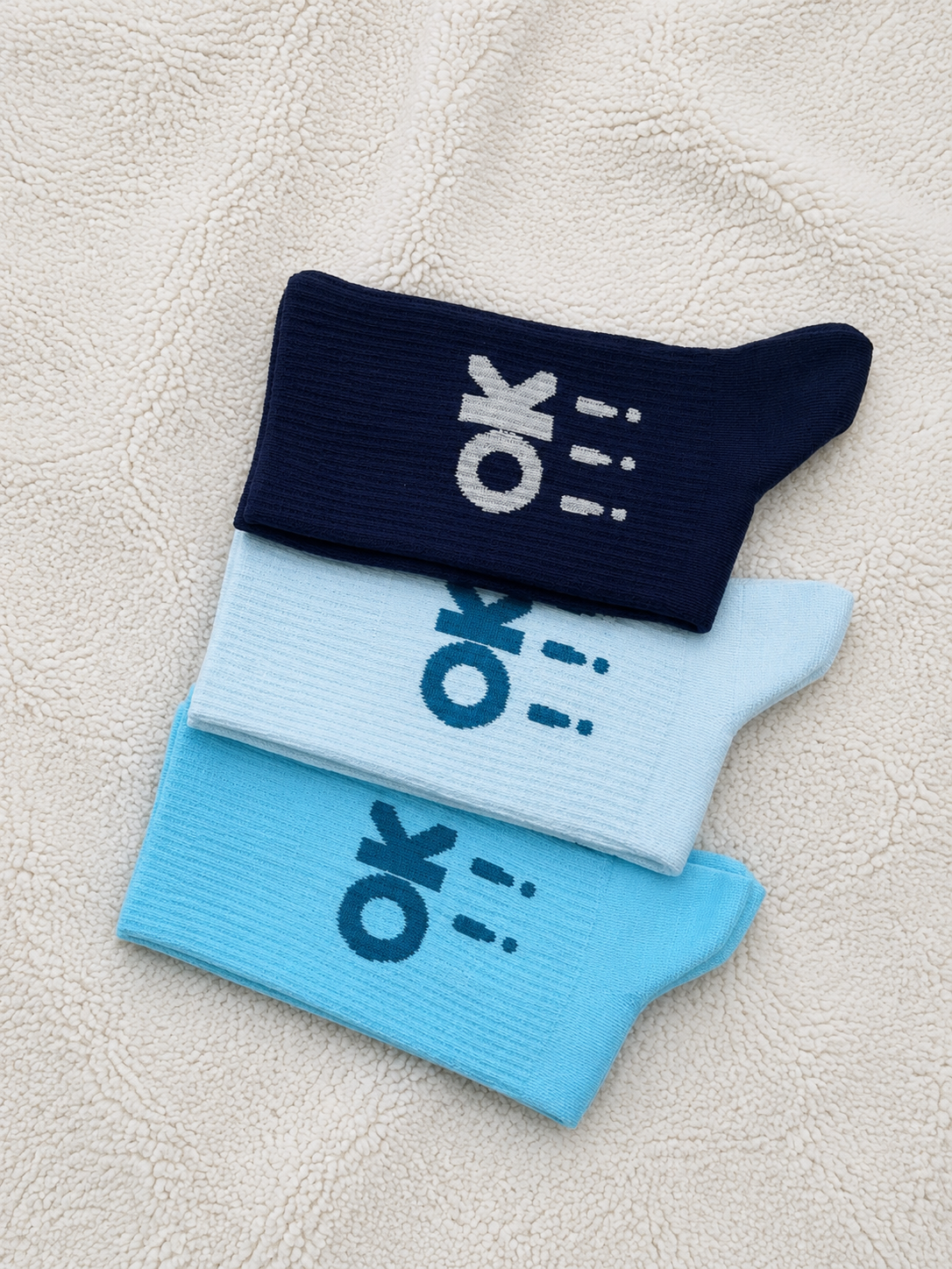OK design long socks in navy, blue and sky blue with sporty graphic pattern.